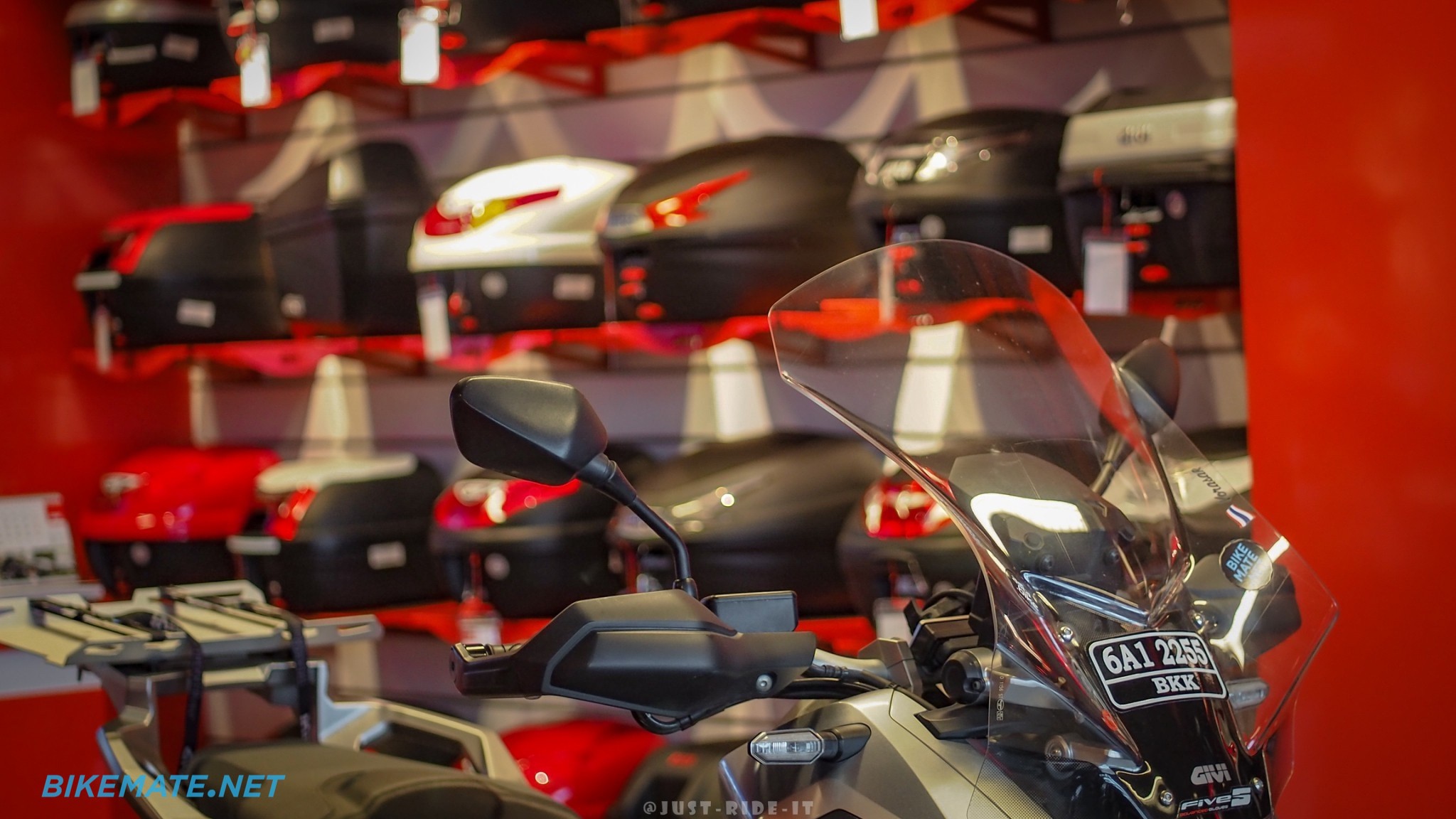 Inside GIVI-Point Bangkok store with top case display and a motorcycle